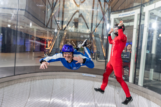 Man flying facing the camera with instructor 3