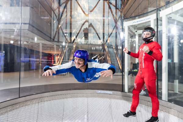 Man flying facing the camera with instructor 6